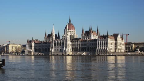 Budapest-city-center-view-with-Parliament-building-and-Danube-river-on-a-sunny-day,-gothic-architecture,-distant-medium-panoramic-shot