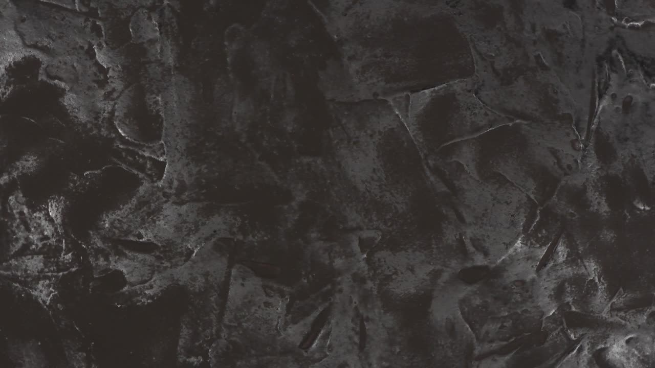 fondo de textura negra. vista superior. movimiento en bucle. rotación 360.