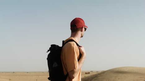 male adventurer crossing the desert