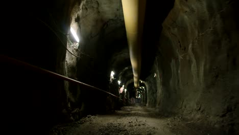 walking pov shot inside a large dark construction tunnel