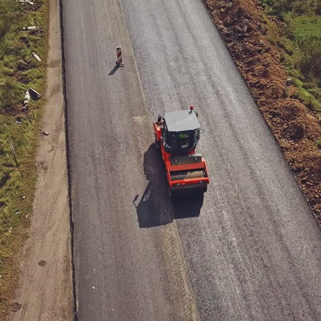 aerial view on the road roller working on the new road construction site. repair of the road in the city