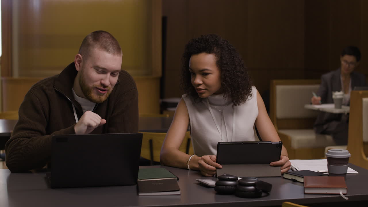 Students collaborating and studying at a cafe