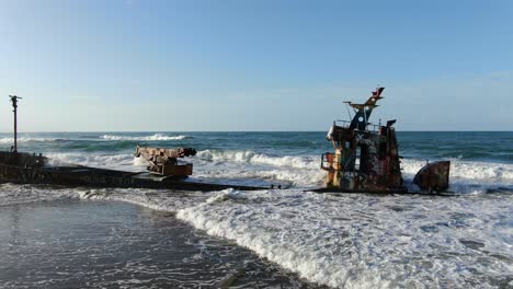 Costa-Rica-beach-drone-view-showing-sea,-shore-and-a-stranded-ship