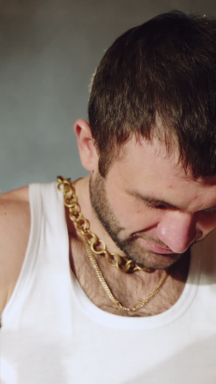 a gangster with handcuffs on his hands is trying to free himself. Drug crime. Vertical video