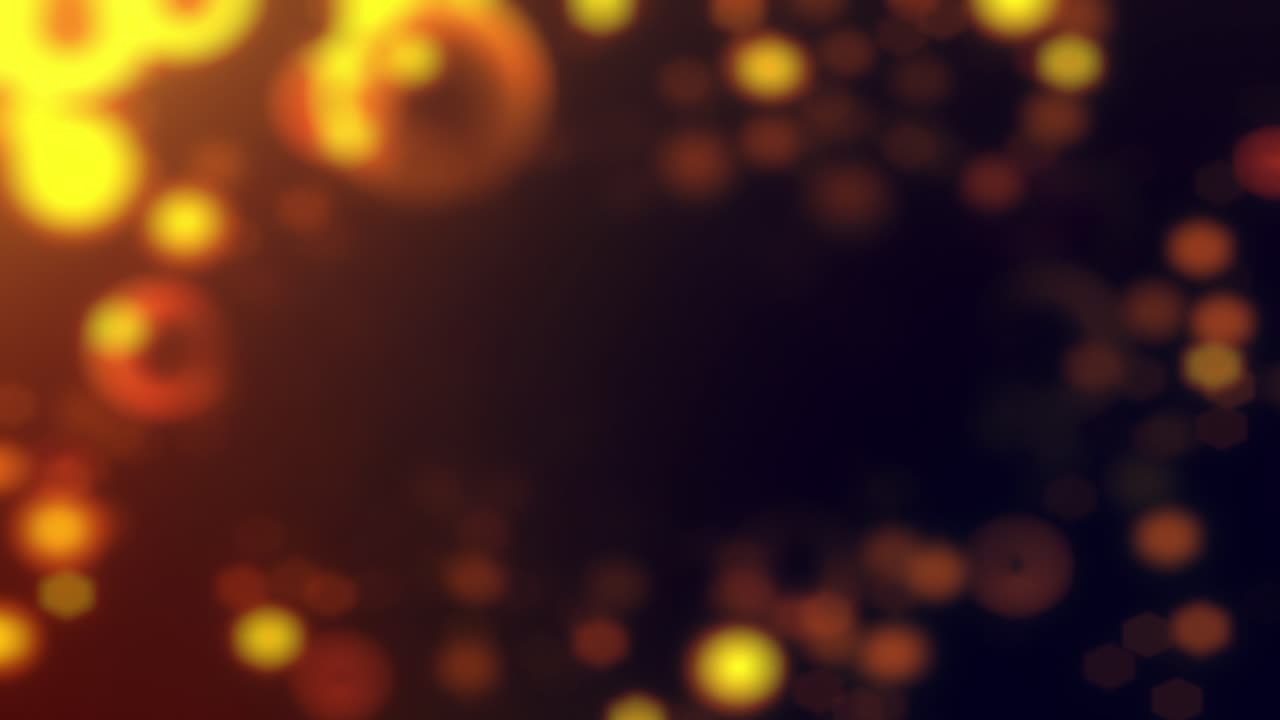 Warm, golden, bubble shaped Bokeh appear and disappear on a dark background, in a looping animation
