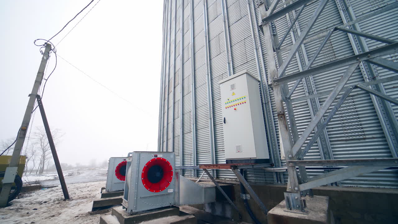 Big stainless elevator industrial tanks. Huge food industry steel storehouse.