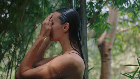 sexy woman in shower wearing bikini washing body cleansing skin with refreshing water enjoying natural beauty spa showering outdoors in nature