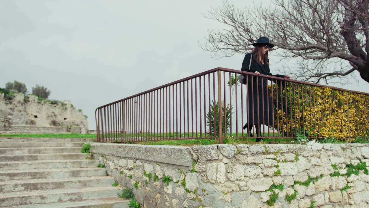 Elegant Woman Walking And Relaxing In The Square Under The Medieval Castle