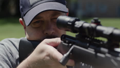 close-up of man firing bolt-action rifle