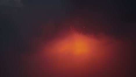 volcan de fuego, guatemala, aerial view of volcano erupting at night shrouded in cloud with lightning flashes