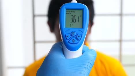 taking body temperature with a non-contact thermometer