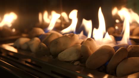 close-up of a modern gas fireplace with smooth stones and blue flames