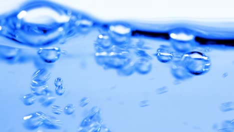 many bubbles in water close up, abstract water wave with bubbles in slow motion