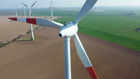 aerial view of wind turbines in a farmland