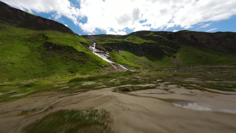 Low-altitude-drone-flight-approaching-a-mountain-waterfall-in-a-valley-of-Grossglockner-alpine-road-in-Austria