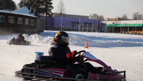 kids go-karting on an ice track in winter