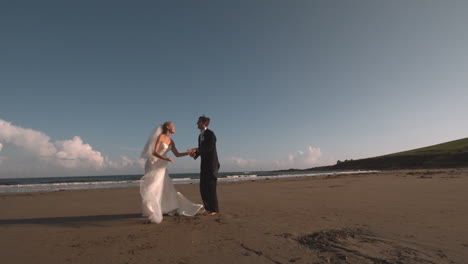 Attractive-newlywed-couple-running-on-the-beach