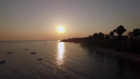 Aerial-scene-of-shore-and-sea-with-boats-at-sunset-Greece