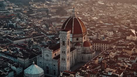 lower orbit right around florence duomo dome with golden morning light