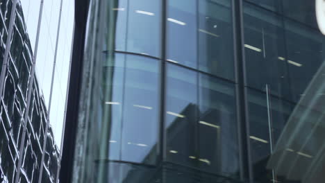 slow travelling shot of glass buildings of the city of london.
