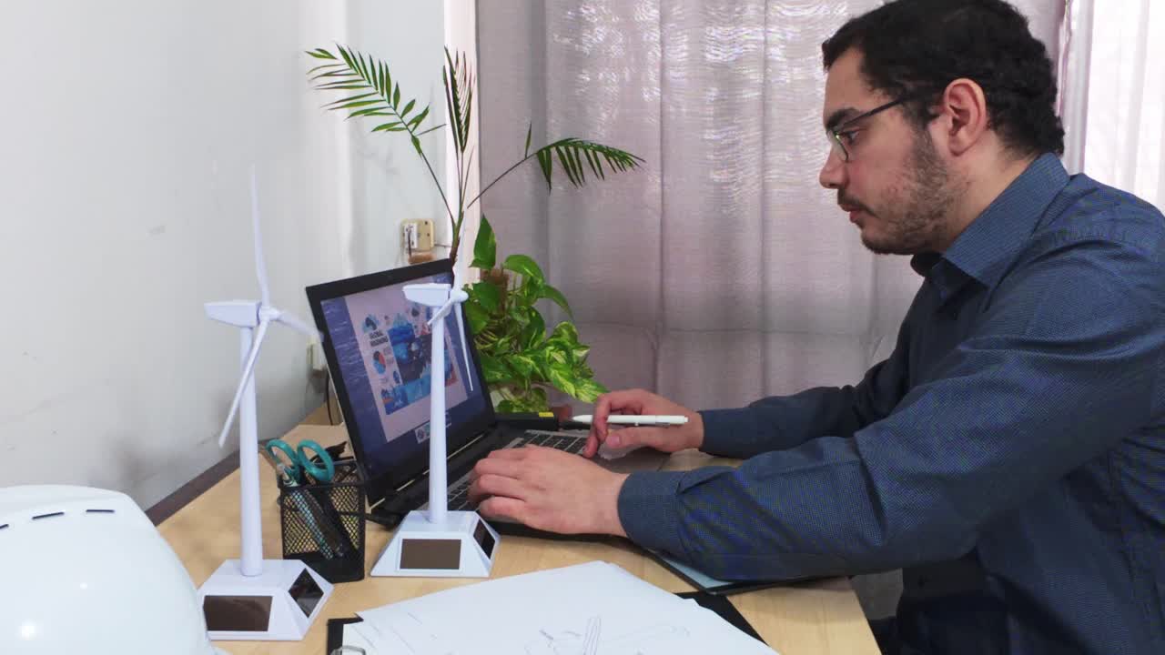 Designer Using a Laptop and Stylus for a Digital Project