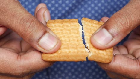 broken cookie in hands