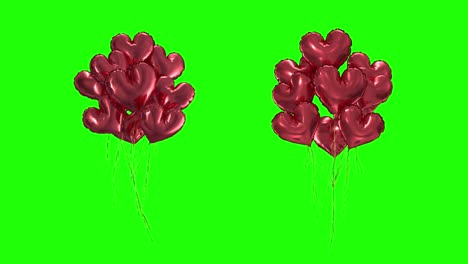 loop bundle of red heartshaped balloons on a green background