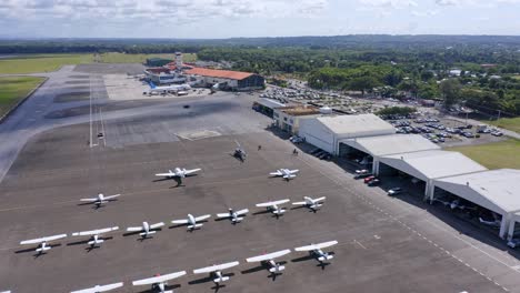 Large-number-of-light-aircraft-parked-on-tarmac,-Cibao-Airport