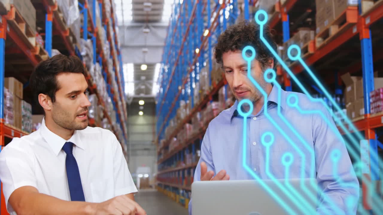 Discussing logistics, two men with digital circuit animation in warehouse