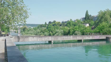 Panning-shot-of-a-canal-above-dam-overflow-Zurich,-Switzerland