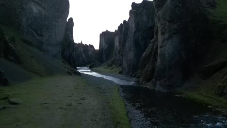 Aerial-view-from-the-the-picturesque-Fjaðrárgljúfur-Canyon-in-South-lceland-during-summer,-surrounded-by-green-vegetation-and-rivers