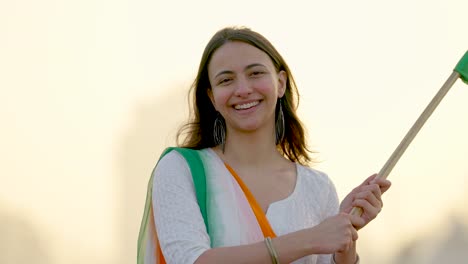 Indian-woman-celebrating-Indian-Independence-Day-at-India-gate-Delhi-by-hoisting-Indian-flag