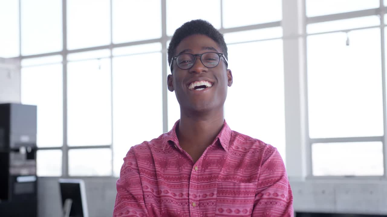 Young handsome African american male executive standing in modern office 4k