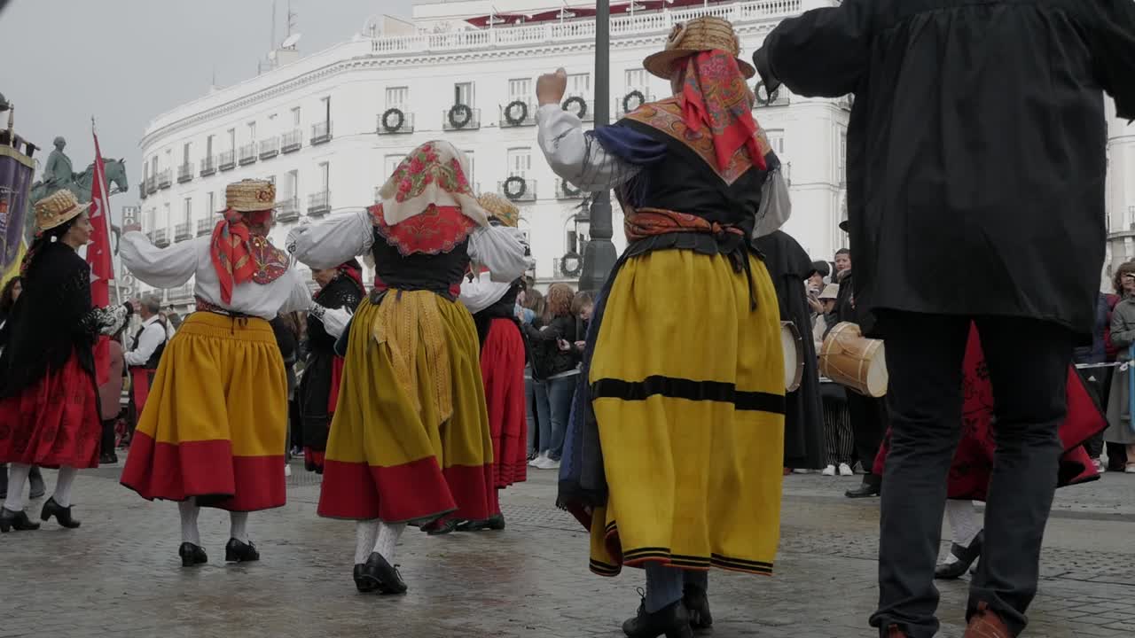 Traditional dancers in colorful dresses perform at Madrid’s Transhumance Festival in Plaza de Sol