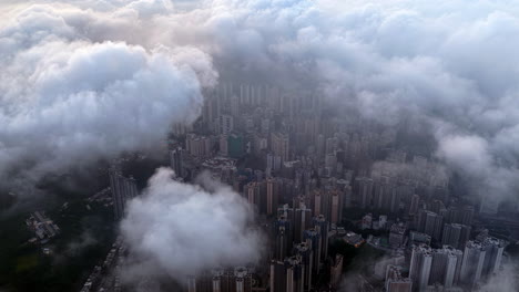 Cinematic aerial view of Hong Kong skyline shrouded in mist at blue hour, with glowing skyscrapers and Victoria Harbour fading into a moody, atmospheric twilight