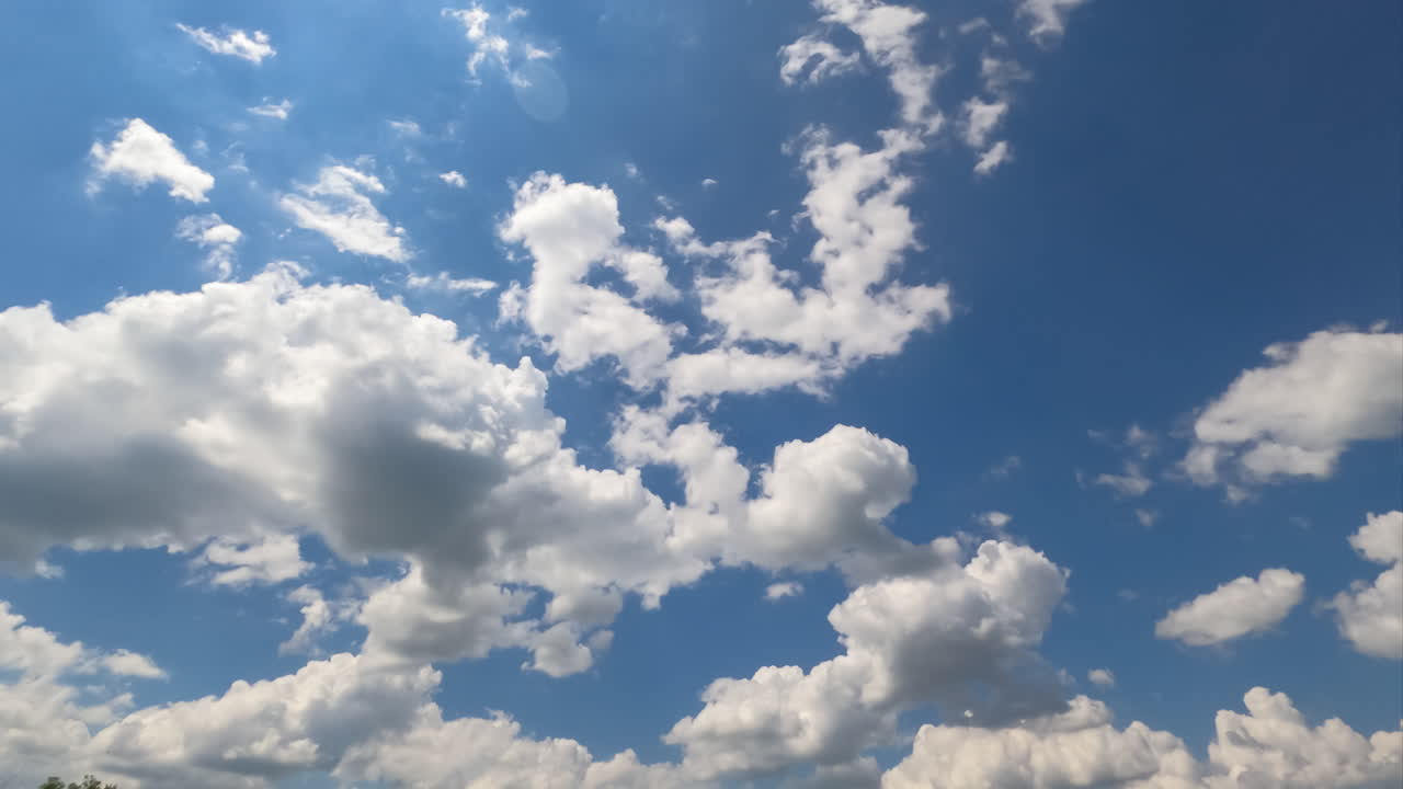 Cloudscape formation at daytime. Beautiful light cotton clouds changing shape in the blue sky. Timelapse.