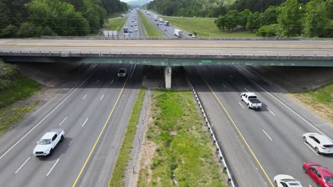 Vehicles-passing-under-an-overpass-on-a-divided-highway