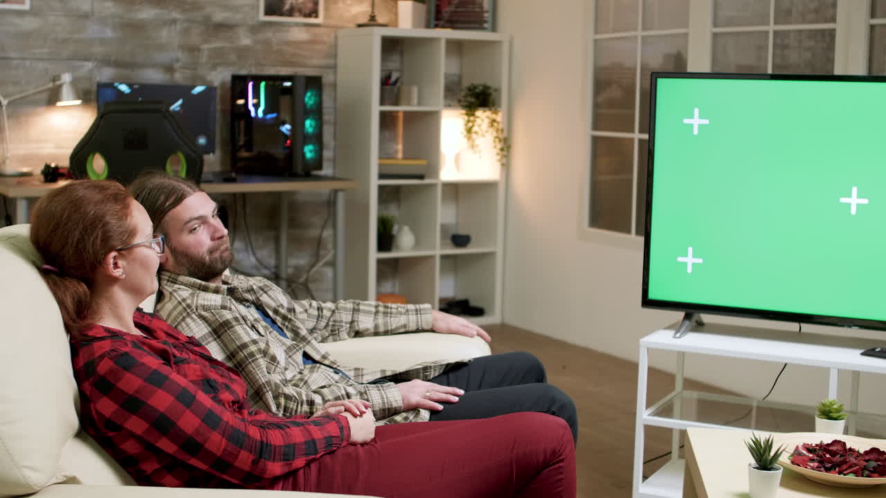 Couple Watching Television with Green Screen