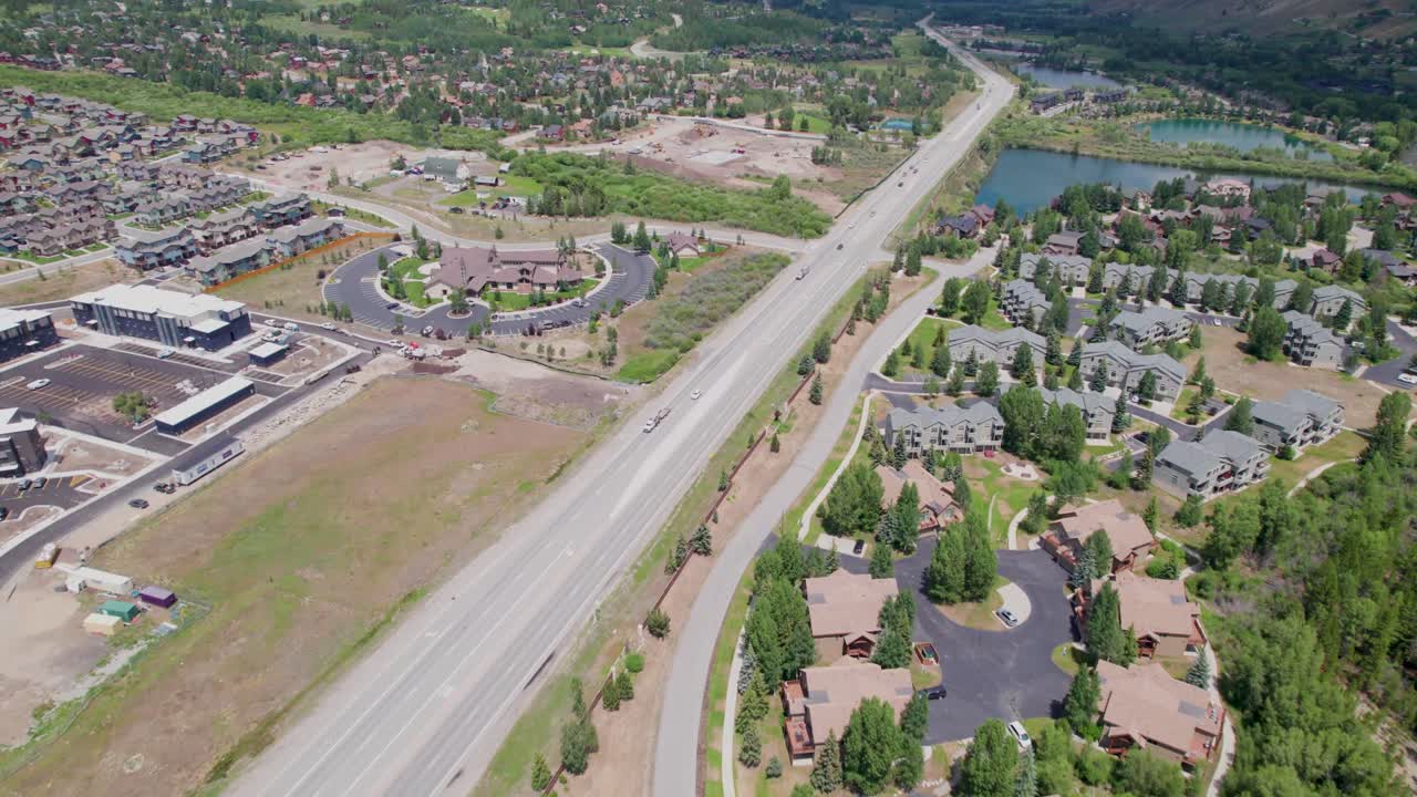 Aerial flight over Silverthorne Colorado. Camera is flying approximately northwest and flies over buildings and Blue River Parkway.