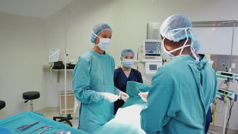 surgical team working on patient in hospital operating theatre