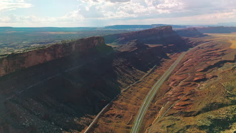 highways and tracks going under the stunning mountains of utah, usa. beautiful sunny scenery of canyons at the backdrop of cloudy sky.