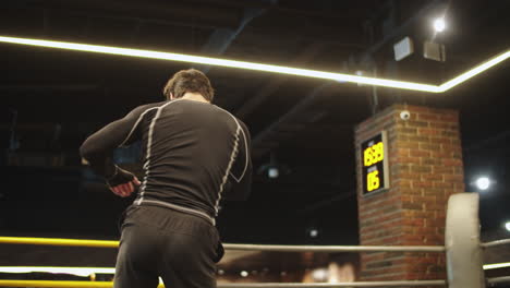 Joven-Deportista-Calentando-En-El-Gimnasio.-Boxeador-Masculino-Haciendo-Golpes-En-El-Ring-De-Boxeo