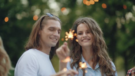 young people at celebration party with sparklers