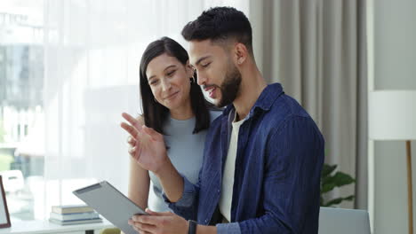 Young-couple-remote-working-at-home-on-a-tablet