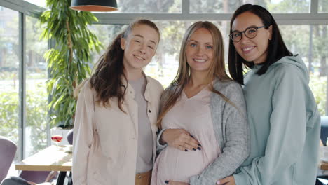 three women celebrating pregnancy