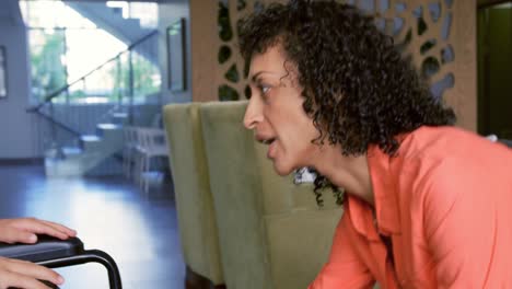 Close-up-of-African-american-mother-consoling-her-disabled-son-in-the-lobby-at-hospital-4k