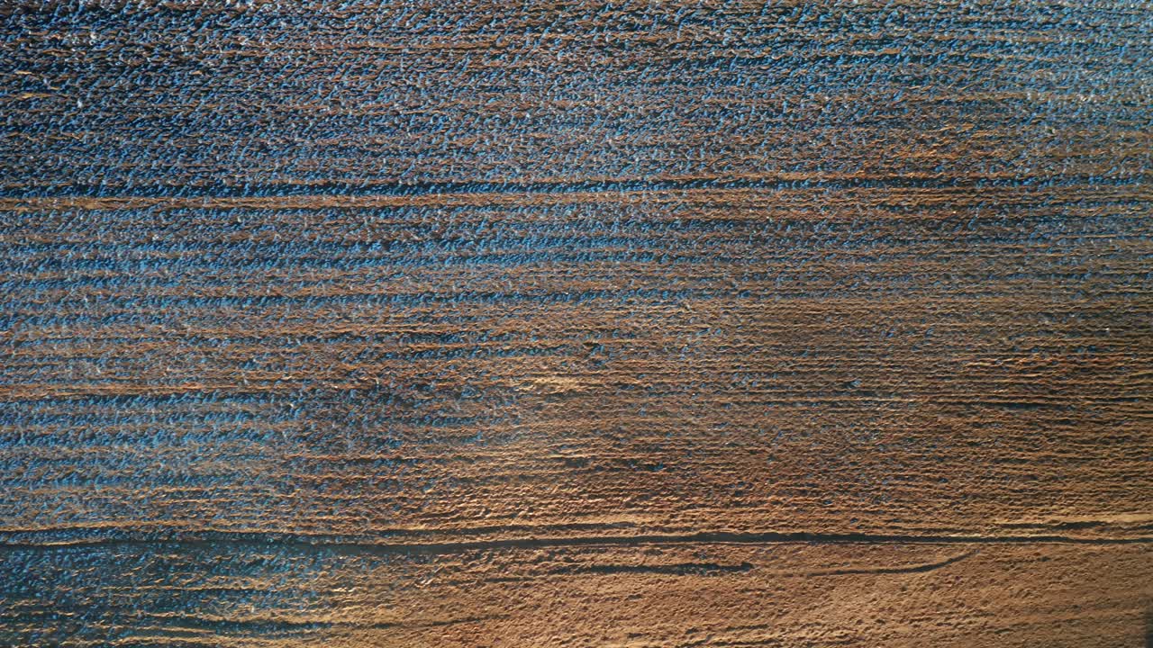 AERIAL: Plowed Farm Area on a Sunny Day in Eastern Europe During Golden Hour