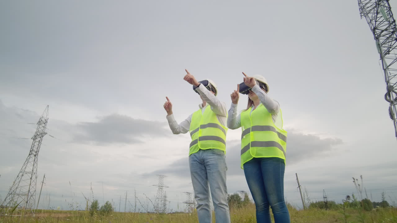 Engineers work with augmented reality using 3D virtual reality glasses. Female and male engineer works with VR glasses while a man holds.