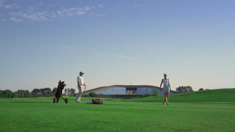 Professionals-golf-group-play-sport-game-on-field.-Business-couple-enjoy-sunset.