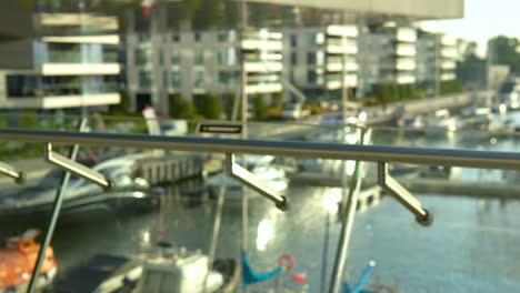 panning view of glass balustrades with marina in backgound